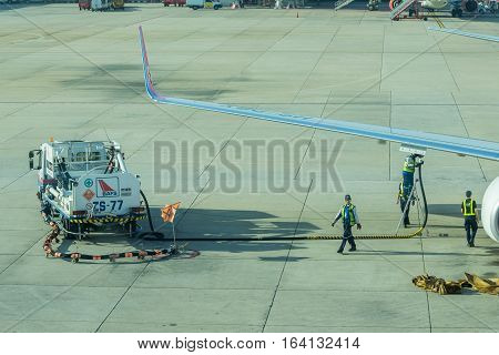 BANGKOK, THAILAND - DEC 29 2016. airport officer and truck Refueling of the aircraft at Don Mueang international airport (DMK)