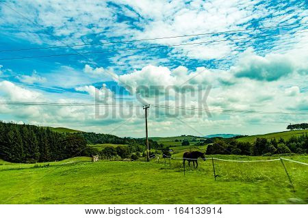 landscapes of agricultural fields photographed from the car near blackford town in the Highlands Scotland