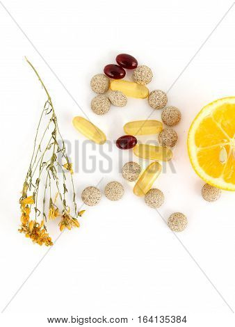 picture of a lemons herbal pills stjohn worth and omega 3 caspules on white background