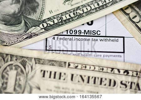 US dollar bills on tax form suggesting tax payment or audit