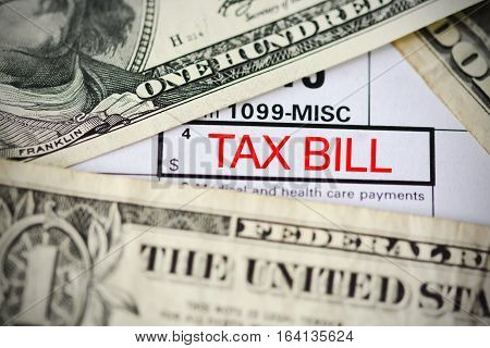 US dollar bills on tax form suggesting tax payment or audit