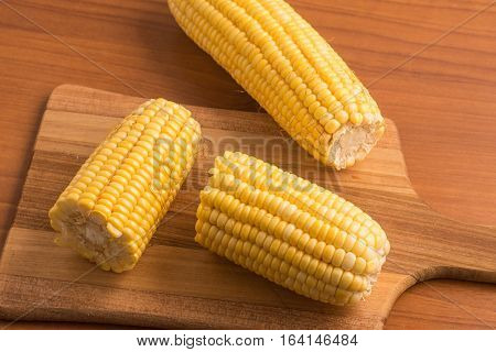 Corn Cob. Milho Verde over a wooden table