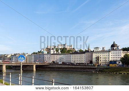 Salzburg skyline with festung hohensalzburg and river salzach salzburger land, bicycle sign, austria
