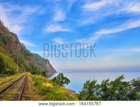 Railroad near Lake Baikal and beautiful sky with cirrus clouds. Irkutsk region. Russia