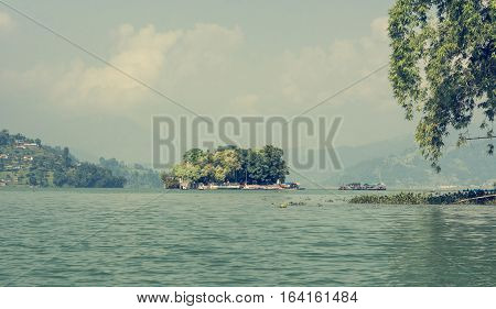 Small island with trees surrounding a monastery. Taal Barahi Temple on Lake Phewa, Pokhara in Nepal.