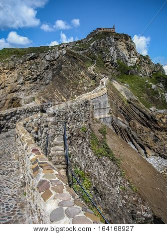 Gastelugache -  island on  coast of  Bay of Biscay belonging to  municipality of Bermeo, Basque Country.  Island is connected to  mainland by  man-made bridge that goes into  winding staircase that spans 237 degrees.