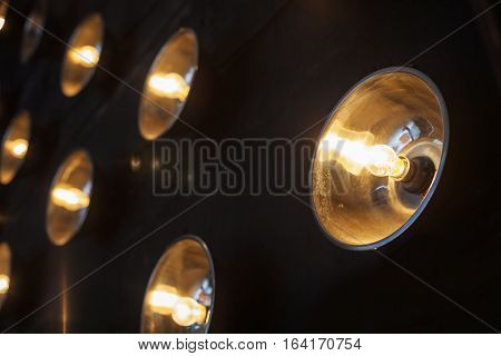 black wall with twelve included glowing spotlights