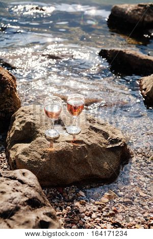 Strawberry Champagne cocktail. rocky beach and sea view