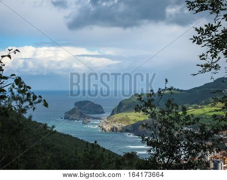Gastelugache -  island on  coast of  Bay of Biscay belonging to  municipality of Bermeo, Basque Country.  Island is connected to  mainland by  man-made bridge that goes into  winding staircase that spans 237 degrees.