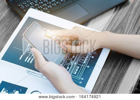 business technology concept Business people hands use smart phone and laptop for business analyst project on table selective focus.