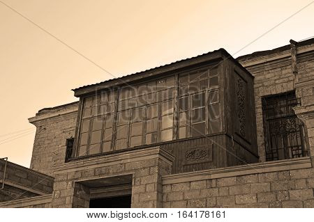 Old balcony in the old town of Baku (Icheri Sheher). Photo with sepia effect