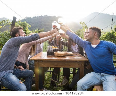 Group of friends at restaurant outdoors - People having dinner in a home garden