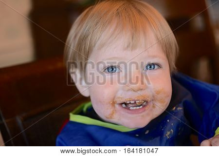 toddler baby boy with face covered in peanut butter