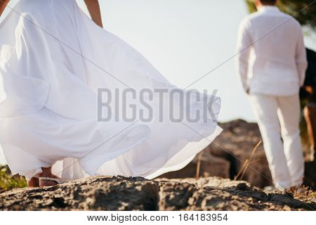 romantic couple relax on rocky beach. Pituresque view with mountains and bay.