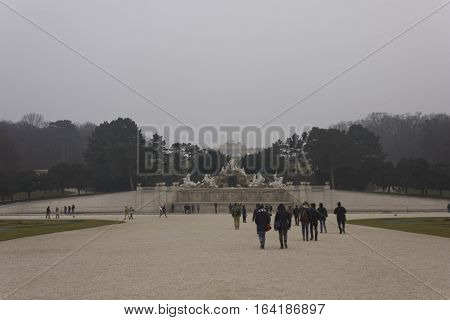 VIENNA, AUSTRIA - JANUARY 2 2016: Schonbrunn park in a foggy winter day with the fountain of the Neptune and the Gloriette building