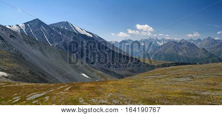 Panorama of the Altai Mountains with snowcaps. View from the highland pass Karaturek.