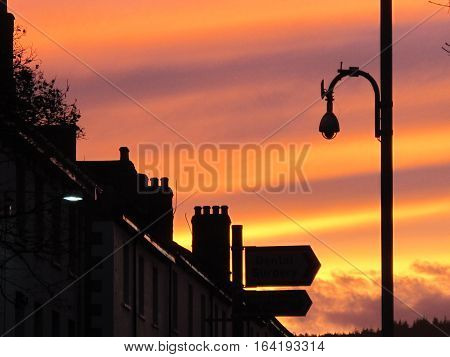 Sunset over a UK city street with a row of terrace houses