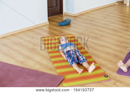 Little boy on a yoga class with a beautiful yoga mat