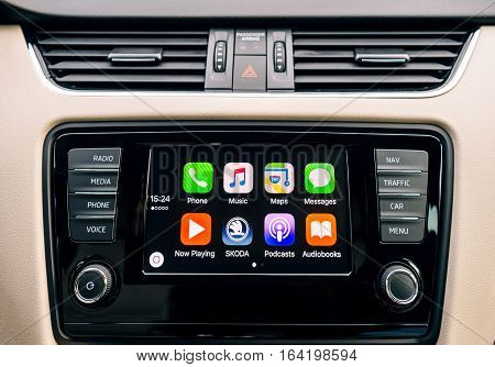 PARIS FRANCE - DEC 13 2016: Apple CarPlay main screen in modern car dashboard. CarPlay is an Apple standard that enables a car radio or head unit to be a display and controller for an iPhone. It is available on all iPhone 5 and later with at least iOS 7.1