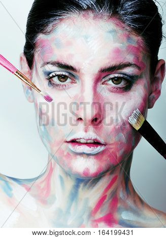 young woman with creative make up like painted oil picture on face closeup