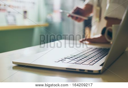 Coffee cup and laptop for business.close up Seleted focus.