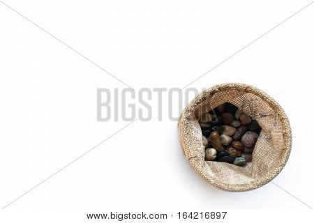 stones for interior decoration in sack bag on white background