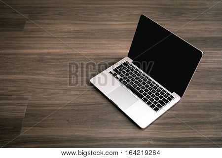 Photograph Of A Laptop Kept On A wooden Floor