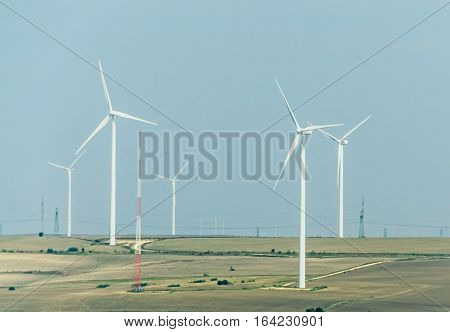 Eolian field and wind turbines farm, countryside.