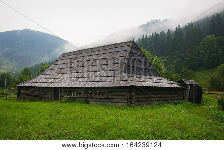 Old wooden hut in Ukrainian mountains Carpathians. The apartments Hutsul family that lived in the last century