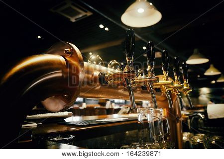 golden shiny beer taps in beer bar