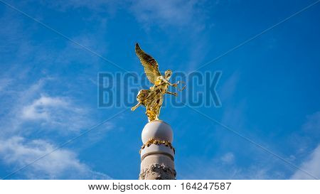 Golden statue with wings and wreath of Sube fountain in Reims, champagne France
