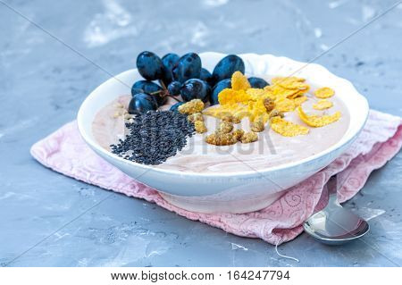 Chocolate smoothie bowl of cereal grapes and mulberries. Love for a healthy raw food concept.