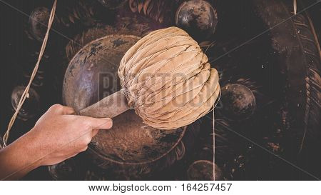 Hand of Asian young man hit big gong or Thai instrument in temple for pray. Thai instrument concept.