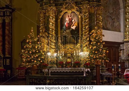 POLAND KRAKOW - JANUARY 01 2015: Side altar of the catholic monastery Church of Sts. Bernardine of Siena with Christmas decorations. The interiors of the church made in baroque style.