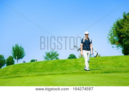 man walking to his golf ball after teeing off