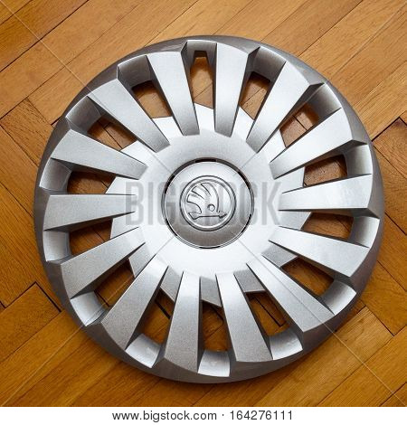 PARIS FRANCE - DEC 18 2016: Modern hubcap hub cover for the winter tyre made by Skoda Auto for Skoda Superb Skoda OCtavia and Skoda Roomster on wooden background