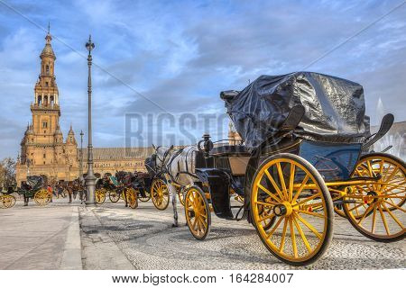 Parked Horse drawn carriages at Plaza de Espana in Seville Andalusia Spain. Spain Square