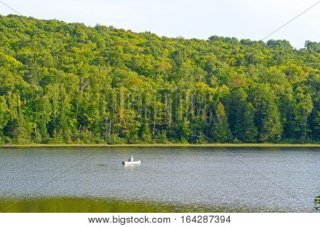 Canoer on a Quiet Lake on Lake of the Clouds in Porcupine Mountains State Park in MIchigan