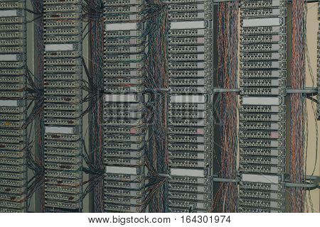 telephone patch panel in datacenter server room, a plurality of cables