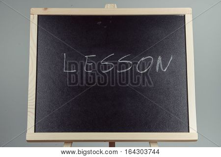 Lesson Written In White Chalk On A Black Chalkboard