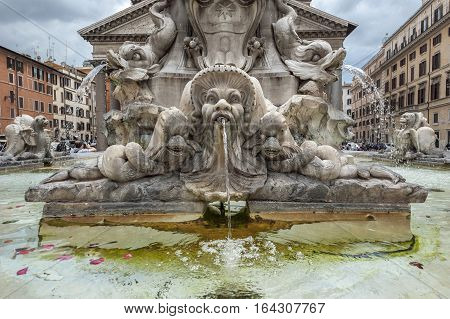 In the center of the piazza is a fountain the Fontana del Pantheon surmounted by an Egyptian obelisk. The fountain was constructed by Giacomo Della Porta under Pope Gregory XIII in 1575 and the obelisk was added to it in 1711 under Pope Clement XI.