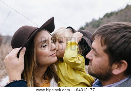happy young family outdoor. mother father and little daughter enjoying life