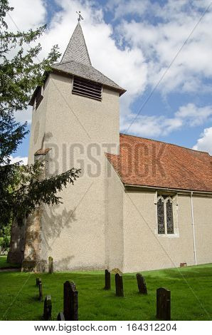 View across the churchyard of the historic Saint Mary the Virgin church in the village of Aldermaston Berkshire. Dating from medieval times the Anglican church still holds regular services.