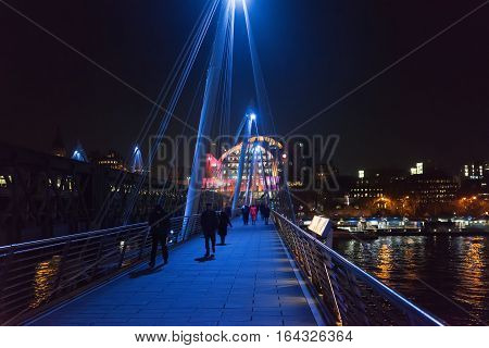 London, UK. 5th January 2017. The Hungerford footbridge with Charing Cross railway station to the side and the River Thames running underneath it. The weather is cold.