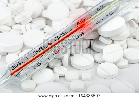 Bunch Of White Tablets With Thermometer. Scattered Pills.