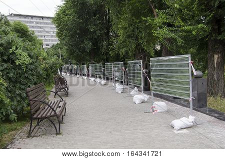Alley in a park with benches and fencing repairs