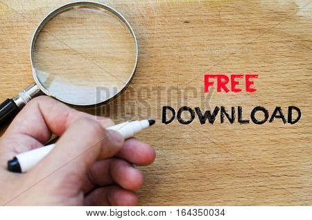 Human hand over wooden background and free download text concept