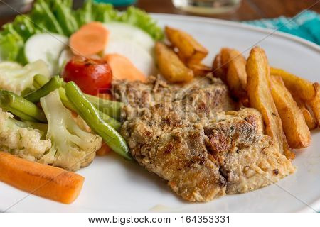Grilled chicken steak with potatoes and vegetables. Healthy and nutritious diet.