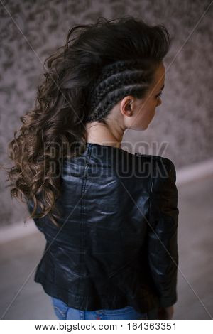 Punk rock style or halloween make-up. Fashion woman model face with bright glamour makeup. Perfect skin, black gloss eyeshadows on eyes and dark brown glossy lips visage. back view