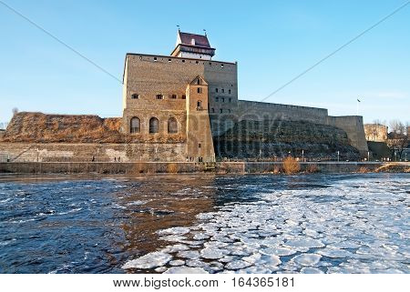 NARVA, ESTONIA - JANUARY 3, 2017: Hermann Castle Museum on the bank of The Narva (Narova) River. The River is a border between Estonia and Russia. View from Russian territory